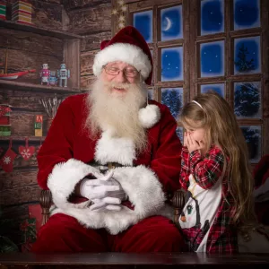 Santa Alan laughing with a little girl during the Magical Santa Experience in Chattanooga, TN